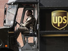 In this Tuesday, May 9, 2017, photo, a UPS driver takes his truck on a delivery route, in New York. UPS is adding a new charge of under $1 for shipments to residential customers during peak delivery periods in November and December. On Monday, June 19, 2017, United Parcel Service Inc. said it will add 27 cents for residential deliveries from Nov. 19 to Dec. 2 and Dec. 17-23. UPS will add a fee of between 81 cents and 97 cents to overnight, second- or third-day deliveries for residential deliveries Dec. 17-23. (AP Photo/Mark Lennihan)