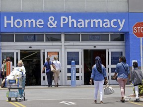 In this Thursday, June 1, 2017, photo, customers shop at a Walmart store in Hialeah Gardens, Fla. Hundreds of inventors are auditioning their wares for Walmart, hopeful the world's largest retailer will consider their products the next big thing and stock them on shelves in nearly 4,700 brick-and-mortar stores. They've already been promised spots on the company's online portals as it battles Amazon for billions of dollars in revenue. (AP Photo/Alan Diaz)