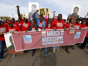 FILE - In this March 4, 2017, file photograph, auto workers and others march to Nissan Motor Co.'s Canton, Miss., plant, following a pro-union rally. A bid by workers at Mississippi's Nissan Motor Co. plant for United Auto Workers representation could turn on a key voting bloc: the 1,500 Nissan employees who were initially hired through contract labor agencies. (AP Photo/Rogelio V. Solis, File)