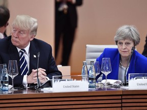 US President Donald Trump, left,  and Britain's Prime Minister Theresa May wait for  the start of the first working session of the G-20 meeting in Hamburg, northern Germany, on Friday, July 7, 2017.  (John MacDougall/Pool Photo via AP)