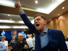 Wildrose leader Brian Jean celebrates the yes vote following the party's vote on uniting with the Progressive Conservatives, in Red Deer Saturday.