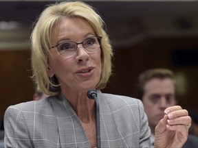 FILE - In this June 6, 2017, file photo, Education Secretary Betsy DeVos testifies on Capitol Hill in Washington before the Senate Appropriations Committee, Labor, Health and Human Services, Education, and Related Agencies Subcommittee hearing on the fiscal year 2018 budget. Democratic attorneys general in 18 states and the District of Columbia are suing Education Secretary Betsy DeVos over her decision to suspend rules meant to protect students from abuses by for-profit colleges. The lawsuit was filed Thursday, July 6, 2017,  in federal court in Washington and demands implementation of borrower defense to repayment rules. (AP Photo/Susan Walsh, File)