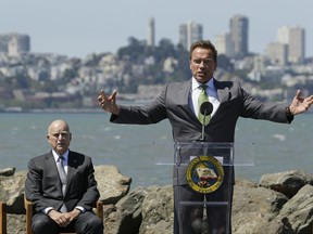 Former California Gov. Arnold Schwarzenegger gestures while speaking as Gov. Jerry Brown, left, listens before a climate bill signing on Treasure Island, Tuesday, July 25, 2017, in San Francisco.