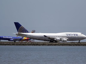 This Tuesday, July 11, 2017, photo, shows a United Airlines jet on a runway at San Francisco International Airport, in San Francisco. United Continental Holdings, Inc. reports financial results, Tuesday, July 18, 2017. (AP Photo/Marcio Jose Sanchez)