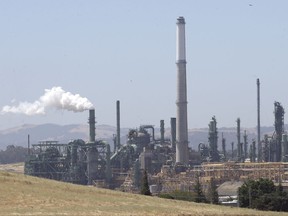 Gov. Jerry Brown is racing to convince state lawmakers to extend California's cap-and-trade program which puts a price on carbon emitted by polluters, including oil refineries like the Valero Benicia Refinery seen Wednesday, July 12, 2017, in Benicia, Calif. The program has been closely watched around the world as a market-based way to reduce greenhouse gas emissions, but it expires in 2020. (AP Photo/Rich Pedroncelli)