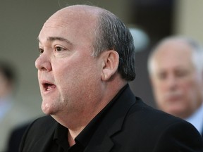 FILE - In this Oct. 21, 2011, file photo, John T. Coli Sr., president of Teamsters Joint Council 25, speaks at a news conference in Chicago. Coli faces federal charges for allegedly threatening to harm a local business if it didn't pay him $25,000 every quarter. A statement Wednesday, July 12, 2017, from the U.S. attorney's office in Chicago says the attempted extortion by Coli started in 2016. (AP Photo/M. Spencer Green, File)