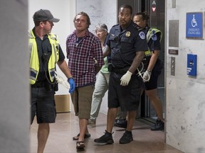 Capitol Hill police officers arrest a group protesting the Republican healthcare bill outside the offices of Sen. Lisa Murkowski, R-Alaska, on Capitol Hill in Washington, Monday, July 17, 2017. The Senate has been forced to put the republican's health care bill on hold for as much as two weeks until Sen. John McCain, R-Ariz., can return from surgery. (AP Photo/Andrew Harnik)