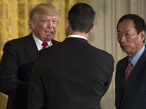President Donald Trump, arrives and greets House Speaker Paul Ryan of Wis., and Terry Gou, president and chief executive officer of Foxconn, in the East Room of the White House in Washington, Wednesday, July 26, 2017. (AP Photo/Carolyn Kaster)