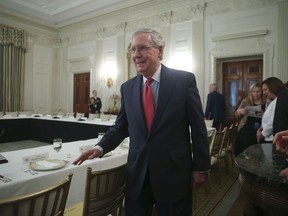 Senate Majority Leader Mitch McConnell of Ky. walks to his seat for a luncheon between GOP leadership and President Donald Trump, Wednesday, July 19, 2017, in the State Dinning Room of the White House in Washington. Americans overwhelmingly want lawmakers of both parties to negotiate on health care, with only 13 percent supporting Republican moves to repeal "Obamacare" absent a replacement, according to a new poll. (AP Photo/Pablo Martinez Monsivais)