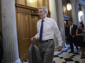 Sen. Rob Portman, R-Ohio, arrives for a vote as the Republican-run Senate rejected a GOP proposal to scuttle President Barack Obama's health care law and give Congress two years to devise a replacement, Wednesday, July 26, 2017, at the Capitol in Washington. President Donald Trump and Senate Majority Leader Mitch McConnell, R-Ky., have been stymied by opposition from within the Republican ranks. (AP Photo/J. Scott Applewhite)