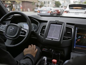 An Uber driverless car waits in traffic during a test drive in San Francisco.