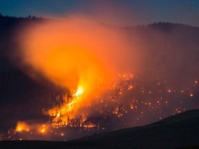 A wildfire burns on a mountain near Ashcroft, B.C., where a state of emergency has been declared after 56 new wildfires started Friday.