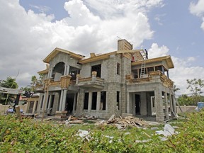 This Thursday, June 8, 2017, photo shows a new home under construction, in Miami Springs, Fla. On Wednesday, July 26, 2017, the Commerce Department reports on sales of new homes in June. (AP Photo/Alan Diaz)
