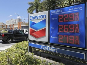 In this Monday, May 15, 2017, photo, motorists pass a Chevron sign listing gas prices, in Miami Springs, Fla. On Friday, July 14, 2017, the  Labor Department reports on U.S. consumer prices for June. (AP Photo/Alan Diaz)