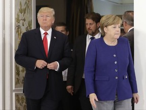 U.S. President Donald Trump, left, and German Chancellor Angela Merkel arrive for a bilateral meeting on the eve of the G-20 summit in Hamburg, northern Germany, Thursday, July 6, 2017. The leaders of the group of 20 meet July 7 and 8. (AP Photo/Matthias Schrader, pool)