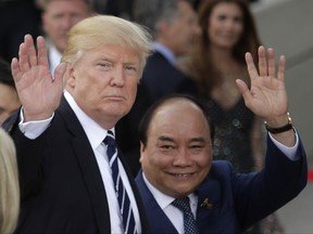 U.S. President Donald Trump, left, and Vietnamese Prime Minister Nguyen Xuan Phuc wave prior to a concert on the first day of the G-20 summit in Hamburg, northern Germany, Friday, July 7, 2017. The leaders of the group of 20 meet July 7 and 8. (AP Photo/Markus Schreiber)