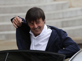 FILE - In this May 18, 2017 file photo, Environment Minister Nicolas Hulot arrives for the first weekly cabinet meeting under new French President Emmanuel Macron, at the Elysee Palace in Paris. Hulot unveiled a five-year plan to fight against climate change and fulfill the country's commitments under the Paris accord. Hulot said France will stop producing power from coal-power station by 2022. (AP Photo/Christophe Ena, File)