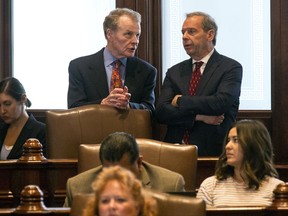 House Speaker Michael Madigan, D-Chicago, left, and Senate President John Cullerton, D-Chicago, talk on the Senate floor Tuesday, July 4, 2017, at the Capitol in Springfield, Ill. The Illinois Senate has OK'd an annual spending plan of $36 billion following a critical vote to raise the income tax rate. If approved by Republican Gov. Bruce Rauner, it would be Illinois' first budget in more than two years. (Rich Saal/The State Journal-Register via AP)