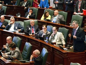 FOR USE MONDAY JULY 10, 2017 AND THEREAFTER - FILE - In this July 6, 2017 file  photo, Rep. David Harris, R-Mount Prospect, left, explains why he would vote to override Gov. Bruce Rauner's veto of a package of budget bills at the Capitol in Springfield, Ill. Ten Republicans voted with Democrats to overturn the governor's veto approving the first state budget in more than two years. Democratic Comptroller Susana Mendoza's staff estimates she will be able to cover expenses in August. The law allows for borrowing or taking $1.5 billion from other state funds in the interim. (Rich Saal/The State Journal-Register via AP File)