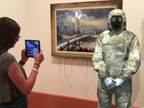 A visitor takes in the augmented reality version of a painting at the AGO's new ReBlink exhibit.