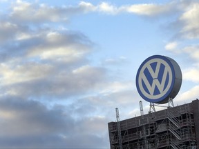 FILE - In this Sept. 26, 2015 file photo a giant logo of the German car manufacturer Volkswagen is pictured on top of a company's factory building in Wolfsburg, Germany. Volkswagen will announce its second-quarter earnings on Thursday, July 27, 2017. (AP Photo/Michael Sohn, file)