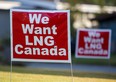 Signs reading "We Want LNG Canada" stand on a lawn in the residential area of Kitimat, British Columbia.