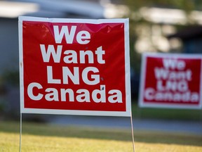 Signs reading "We Want LNG Canada" stand on a lawn in the residential area of Kitimat, British Columbia.