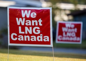 Signs reading "We Want LNG Canada" stand on a lawn in the residential area of Kitimat, British Columbia.