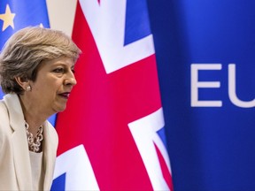 FILE- In this Friday, June 23, 2017 file photo British Prime Minister Theresa May prepares to address a media conference at an EU summit in Brussels. May's office said on Monday, July 31, 2017 that free movement to Britain from European Union countries will end when the U.K. leaves the bloc in March 2019, but it's uncertain what migration arrangements will look like after that. (AP Photo/Geert Vanden Wijngaert, file)
