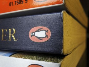 FILE - This Oct. 29, 2012 file photo shows three Penguin published books. British education publishing company Pearson says it will sell 22 percent of its shares in New York-based Penguin Random House to its German co-owner, Bertelsmann.  (Tim Ireland/PA via AP, File)
