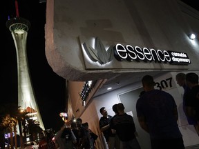 People wait in line at the Essence cannabis dispensary along the Las Vegas Strip, Saturday, July 1, 2017, in Las Vegas. Nevada dispensaries were legally allowed to sell recreational marijuana starting at 12:01 a.m. Saturday. (AP Photo/John Locher)