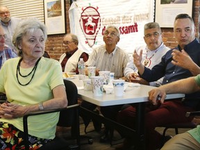 Eric Canapé, right, a member of the Pessamit Innu tribal nation of Quebec, Canada, speaks during a meeting with opponents of a proposed Northern Pass power project Thursday, July 20, 2017, in Concord, N.H. Other tribal members attending include elder Malec Hervieux, fourth from left, Joseph-Louis Vachon, third from right, and Jean-Noël Riverin, second from right. The tribe opposes the U.S. power project, saying it would accommodate a hydro-power company that has decimated a salmon fishery in Quebec that the tribe depends upon. (AP Photo/Bill Sikes)