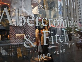 FILE - In this Monday, May 22, 2017, file photo, a store window reflects a street scene at an Abercrombie & Fitch store on New York's Fifth Avenue. On Monday, July 10, 2017, teen retailer Abercrombie & Fitch is no longer looking to sell itself, announcing that it will stick with its current strategy. (AP Photo/Bebeto Matthews, File)