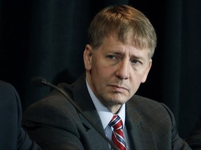 FILE - In this Oct. 7, 2015, file photo, Consumer Financial Protection Bureau Director Richard Cordray listens to a speaker during a hearing in Denver. The CFPB has decided to broadly ban the use of so-called arbitration clauses from financial products. Cordray said mandatory arbitration clauses are a way for banks and other financial companies to "sidestep the legal system." Consumer advocates have been pushing for years for stricter federal regulation of these types of clauses. But the move is likely to face pushback from the banking industry and the Republican-controlled Congress. (AP Photo/Brennan Linsley, File)
