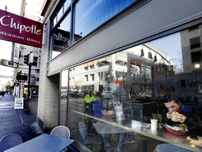 FILE - In this Wednesday, Nov. 11, 2015, file photo, a customer eats lunch at a Chipotle restaurant in Portland, Ore. Chipotle Mexican Grill, Inc. reports financial results, Tuesday, July 25, 2017. (AP Photo/Don Ryan, File)