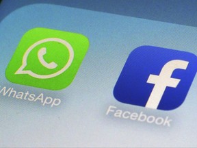 FILE - This Feb. 19, 2014, file photo, shows WhatsApp and Facebook app icons on a smartphone in New York. Facebook has squeezed just about as many ads into its main platform as it can. Any more and users might start to complain. Now, ads are moving on to Messenger, and WhatsApp may not be too far behind. (AP Photo/Patrick Sison, File)