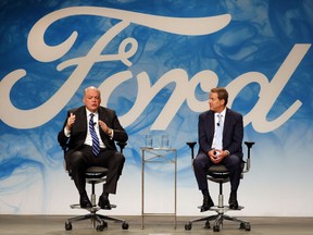 FILE - In this Monday, May 22, 2017, file photo, Bill Ford Jr., right, executive chairman of Ford Motor Company, introduces Jim Hackett as CEO, in Dearborn, Mich. The Ford Motor Co. reports earnings, Wednesday, July 26, 2017. (AP Photo/Paul Sancya, File)