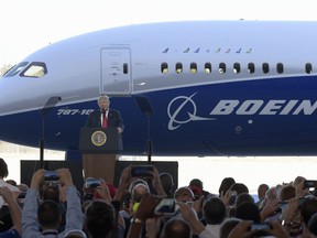 FILE - In this Friday, Feb. 17, 2017, file photo, U.S. President Donald Trump speaks in front of a Boeing 787 Dreamliner while visiting the Boeing South Carolina facility in North Charleston, S.C. Trump's push to get Americans to embrace goods "Made in USA" is harder than it looks. Few products are American-made only. Trump himself signs laws with gold-plated pens assembled in Rhode Island but lacquered and engraved in China. He praises U.S. industrial might in front of a Boeing jet whose parts are 30 percent foreign-made. And there's a good reason why this is the case: U.S. manufacturers rely on global supply chains and Americans buy foreign goods because they prefer lower prices. (AP Photo/Susan Walsh, File)