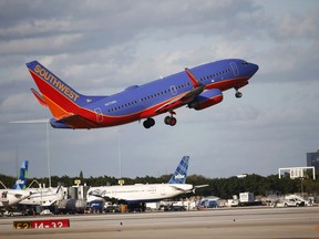 FILE - In this Friday, Feb. 10, 2017, file photo, a Southwest Airlines plane takes off from Palm Beach International Airport in West Palm Beach, Fla. Southwest Airlines Co. reports earnings, Thursday, July 27, 2017. (AP Photo/Wilfredo Lee, File)