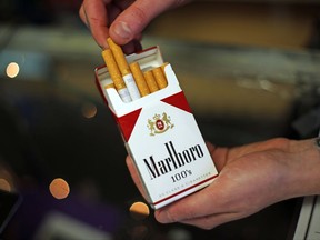 FILE - This July 17, 2015, file photo, shows a pack of Marlboro cigarettes, an Altria brand, at a Smoker Friendly shop in Pittsburgh. Altria Group reports earnings, Thursday, July 27, 2017. (AP Photo/Gene J. Puskar, File)