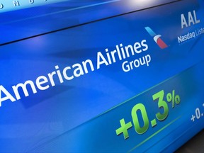 In this Tuesday, July 25, 2017, photo, American Airlines Group stock value appears on a screen at the Nasdaq MarketSite, in New York. American Airlines Group, Inc. reports earnings Friday, July 28, 2017. (AP Photo/Mark Lennihan)