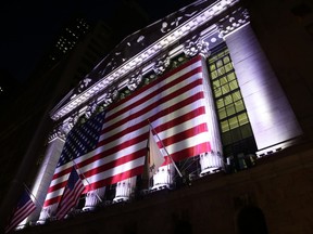 FILE - In this Friday, Feb. 17, 2017, file photo, an American flag hangs on the front of the New York Stock Exchange, after the markets closed. U.S. stocks are bouncing back early Friday, July 7, 2017, after the government said hiring grew at a stronger pace in June. Technology companies are making some of the biggest gains while energy companies decline with oil prices. A day earlier stocks took their biggest loss since mid-May following a disappointing measurement of hiring by private companies. (AP Photo/Peter Morgan, File)