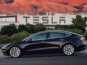 This undated image provided by Tesla Motors shows the Tesla Model 3 sedan. The electric car company's newest vehicle, the Model 3, which set to go to its first 30 customers Friday, July 28, 2017, is half the cost of previous models. Its $35,000 starting price and 215-mile range could bring hundreds of thousands of customers into Tesla's fold, taking it from a niche luxury brand to the mainstream. (Courtesy of Tesla Motors via AP)