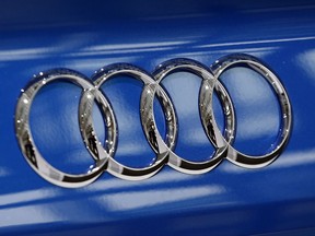 FILE - In this March 3, 2016 file photo the four ring logo of German car producer Audi is photographed during the annual press conference in Ingolstadt, Germany. A former high-level executive for Volkswagen's Audi luxury brand has been charged with conspiracy and accused of directing other employees to program vehicles to cheat on emissions tests. The Justice Department says Giovanni Pamio, an Italian citizen, was charged Thursday, July 6, 2017, in a criminal complaint with conspiracy, wire fraud and violating the Clean Air Act. (AP Photo/Matthias Schrader, File)