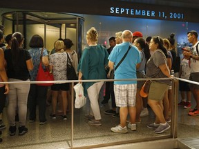 In this July 11, 2017 photo, visitors to the National September 11 Memorial and Museum line up for entrance to the historical exhibition hall in New York. Last winter the U.S. tourism industry worried about a "Trump slump," fearing that Trump administration policies might discourage international travelers from visiting the U.S. But statistics from the first half of 2017 suggest that the travel to the U.S. is robust and a number of sectors have reported increased international visitation, with one expert calling it a "Trump bump." The museum is among those reporting more international visitors this year compared the same period in 2016. (AP Photo/Kathy Willens)