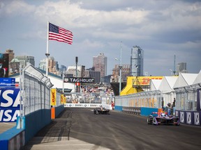 Sam Bird, right, drives during the Formula E all-electric New City ePrix Saturday, July 15, 2017, in the Brooklyn borough of New York. (AP Photo/Michael Noble Jr.)