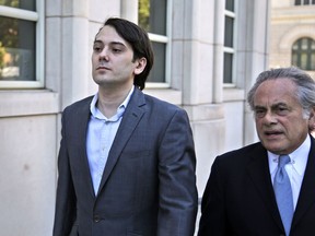 FILE - In this June 26, 2017, file photo, former Turing Pharmaceuticals CEO Martin Shkreli, left, arrives at federal court with his attorney Benjamin Brafman in New York. The jury at the securities fraud trial of "Pharma Bro" Martin Shkreli has heard investors accuse the quirky former biotech CEO of repeatedly giving them the runaround when they tried to pull their money out of his failing health care hedge fund. But the government witnesses have made a concession that the defense hopes plays in its favor: In the end, they made a killing. (AP Photo/Seth Wenig, file)