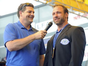 FILE – In this July 17, 2010, file photo, former Ohio State linebacker Chris Spielman, right, jokes with host Mike Golic after receiving his College Football Hall of Fame jacket during the Hall Enshrinement Festival in South Bend, Ind. Spielman filed a federal lawsuit Friday, July 14, 2017, against the university on behalf of several of the school's most famous former student-athletes including running back Archie Griffin, lineman Jim Stillwagon, safety Mike Doss and others, over a marketing program the ex-athletes say used their photos without permission and robbed them of compensation. (AP Photo/Joe Raymond, File)