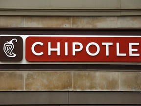 This Thursday, Jan. 12, 2017, photo shows a sign on a Chipotle restaurant. Chipotle says it temporarily shut down a restaurant in Virginia, on Monday, July 17, 2017, after becoming aware of reports of illnesses. The chain says it's working to understand the cause, but that the reported symptoms are consistent with norovirus. The company says it plans to reopen the location in Sterling, Va., after a "complete sanitization" later on Tuesday, July 18, and that its food is safe to eat. (AP Photo/Gene J. Puskar)