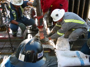 Workers examining a core sample at the Jansen project.